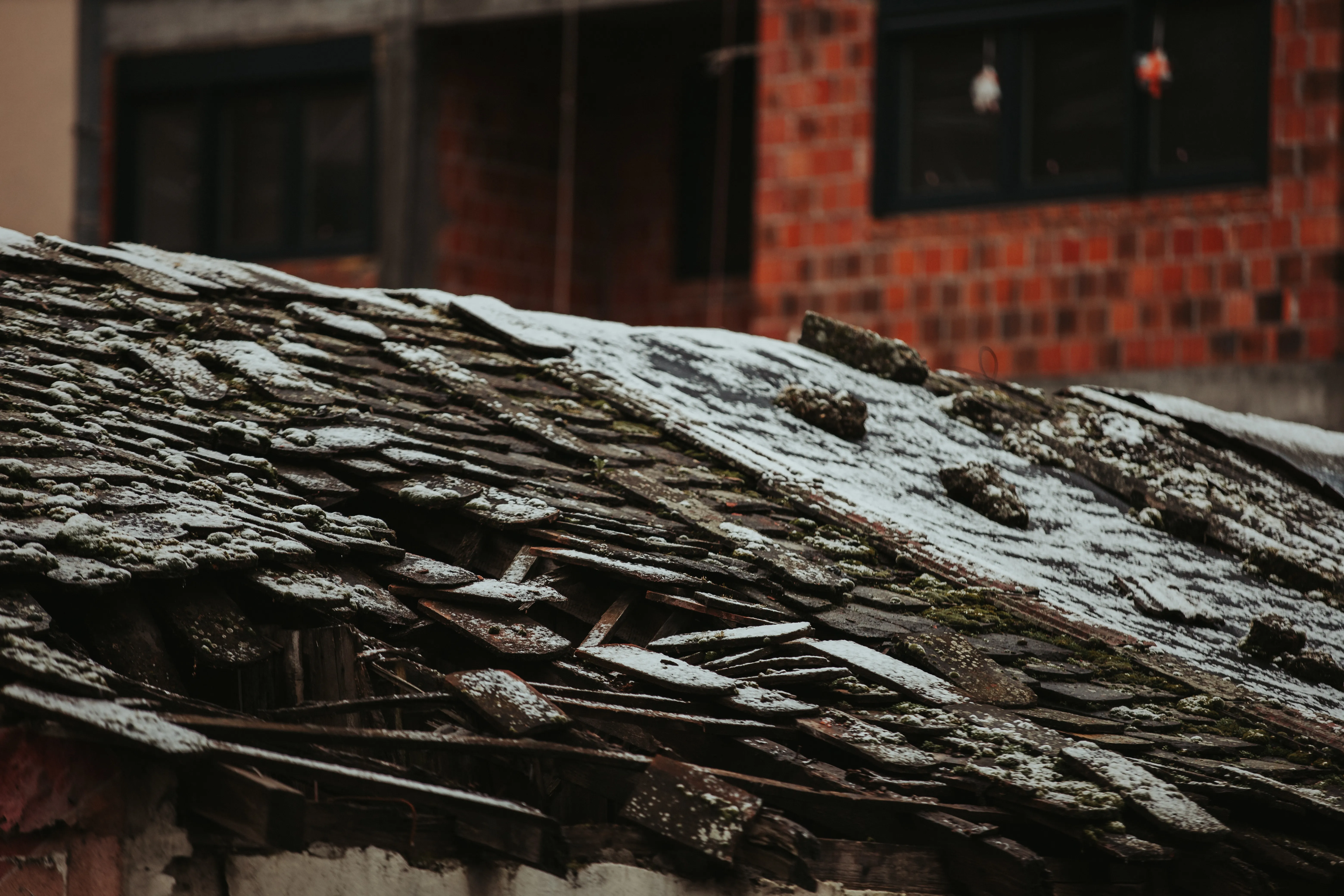 Damaged roof covered in snow after a winter storm in New York